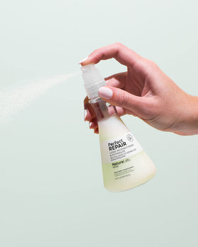 NatureLab.TOKYO held in hand to show 120 ml scale and travel-friendly size