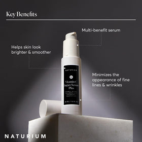 Lifestyle flatlay of Naturium serum with skincare items showing routine simplicity