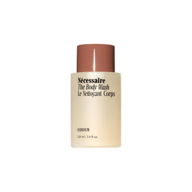 Nécessaire front packaging of mini body wash highlighting travel size and radiance benefits