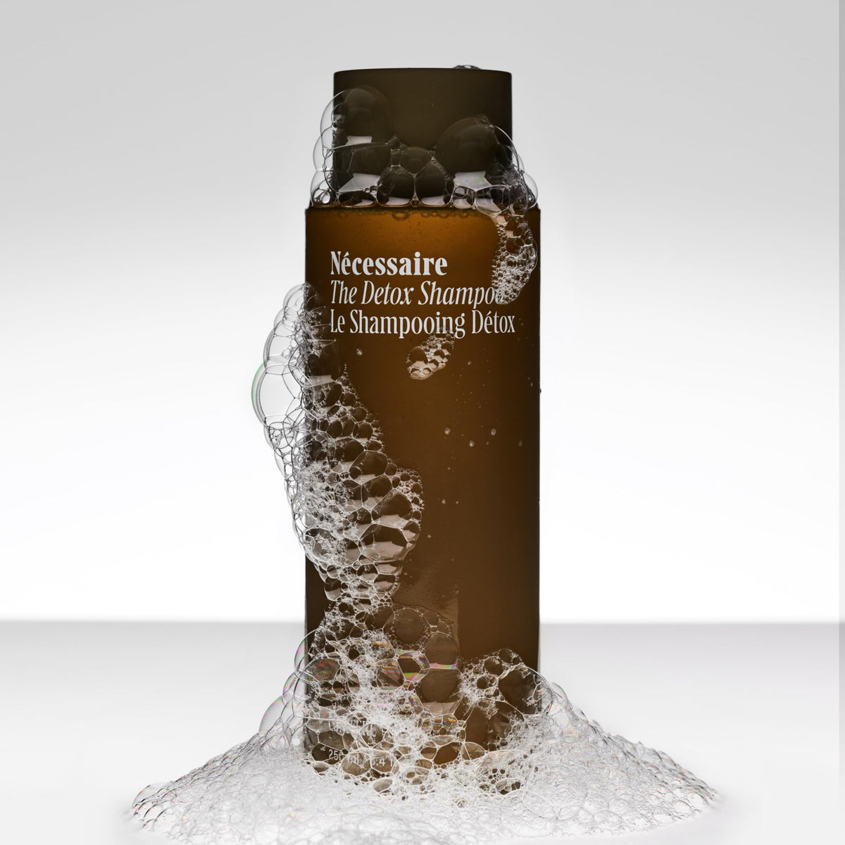 Nécessaire close-up of shampoo texture highlighting creamy clarifying formula