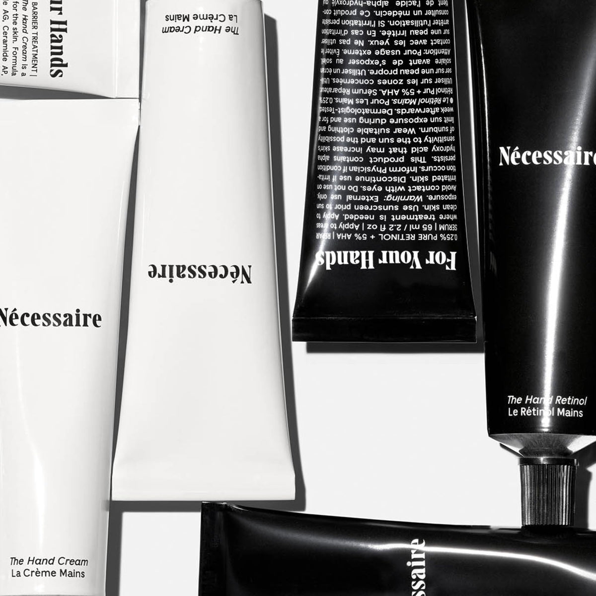 Nécessaire hand retinol balm open on palm demonstrating balm texture and overnight repair