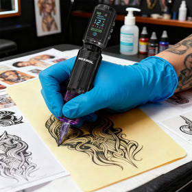 Neebol in use with tattoo artist holding rotary pen for cordless freedom