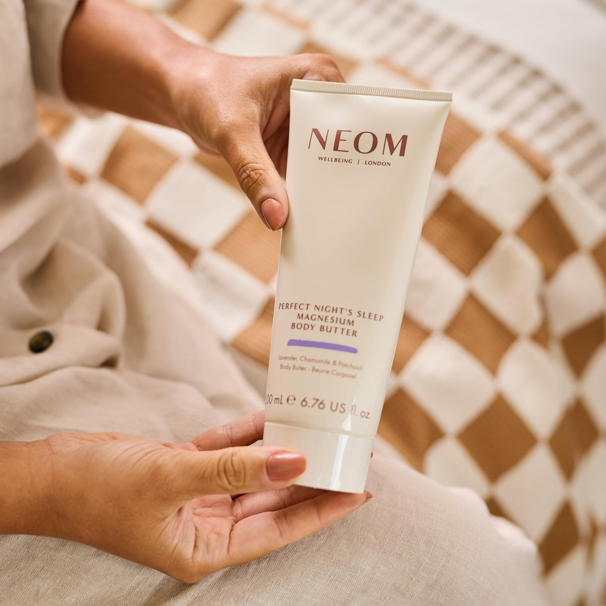 Neom open jar revealing creamy texture for deep skin nourishment