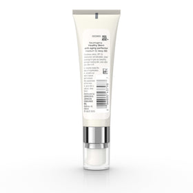 Neutrogena 1 fl oz tube next to a coin to show compact travel-friendly size for on-the-go use