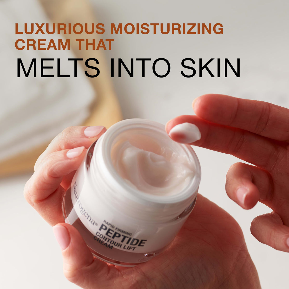 Neutrogena cream applied to hand demonstrating smooth spreadability