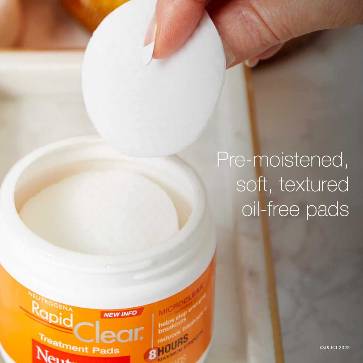 Neutrogena open tub revealing stacked pre-moistened pads for quick use