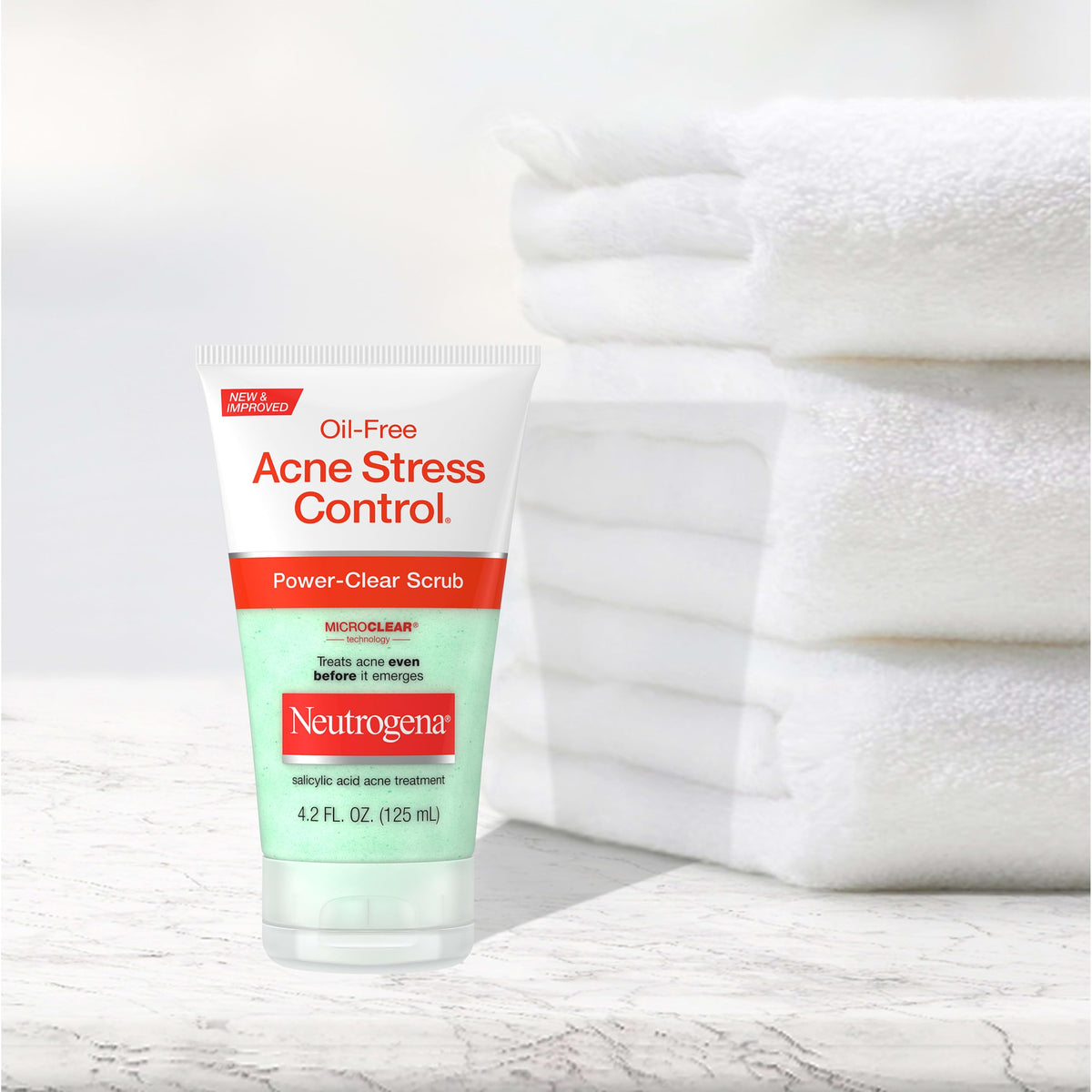 Neutrogena 4.2 fl oz bottle next to common items for scale