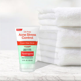 Neutrogena 4.2 fl oz bottle next to common items for scale