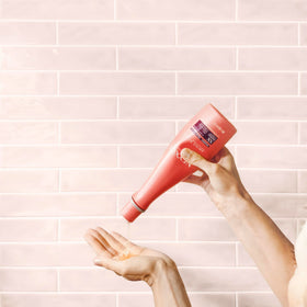 Nexxus bottle styled on bathroom shelf for everyday bathroom display