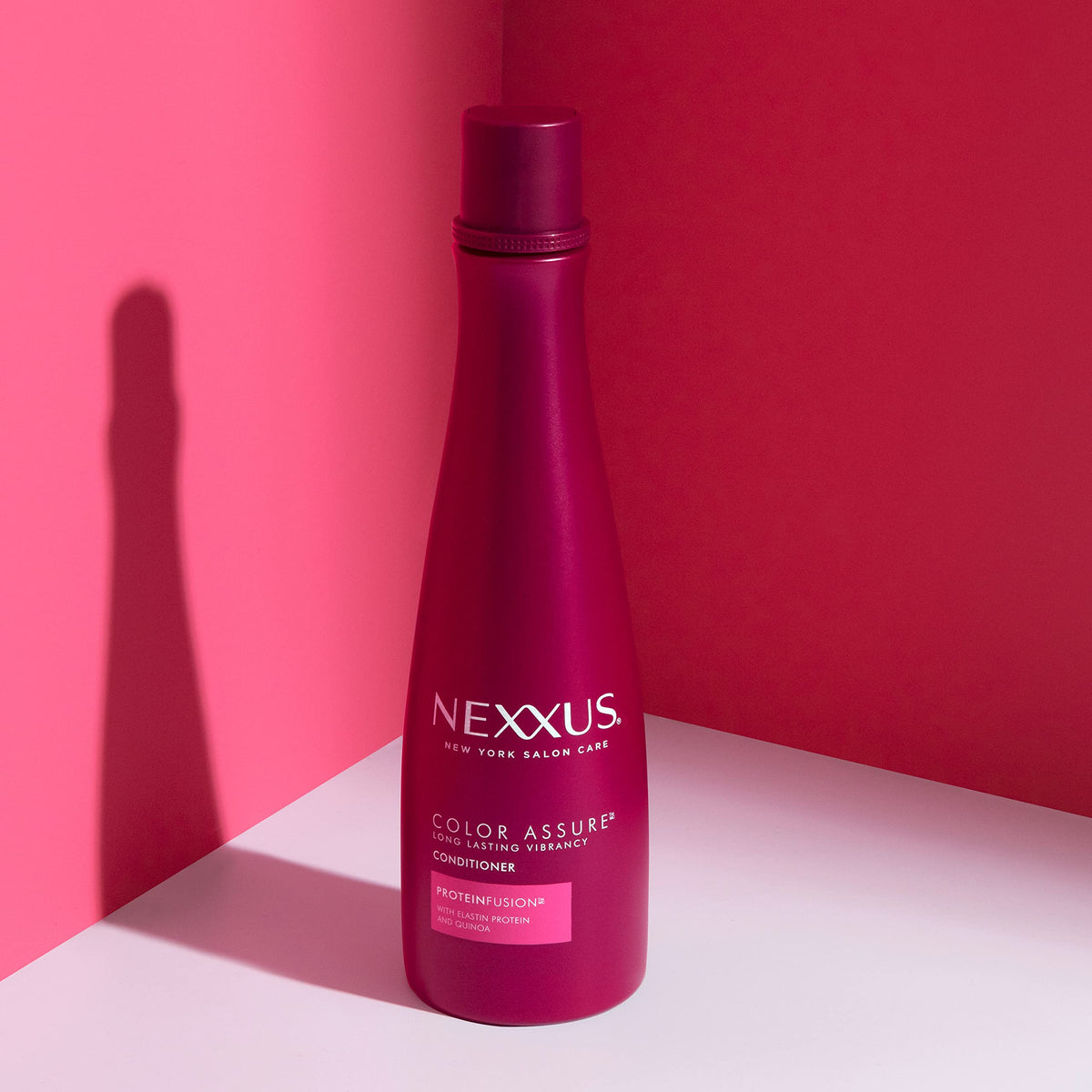 Nexxus bottle in hand during application demonstrating easy dispensing benefit