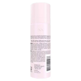 Hand holding Nexxus 1.5 oz can demonstrating compact travel-friendly size