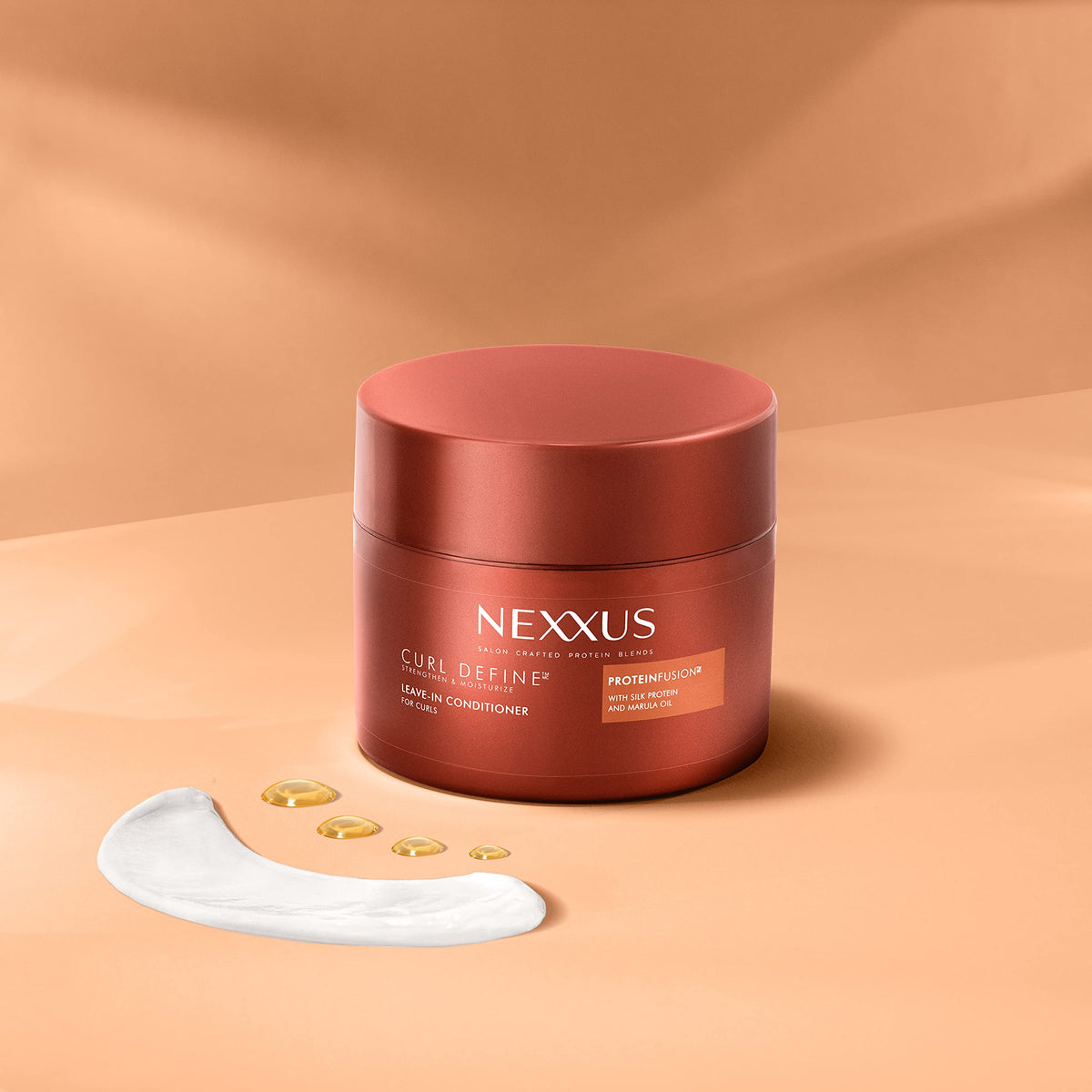Nexxus product in hands applying to damp curls for hydration and definition