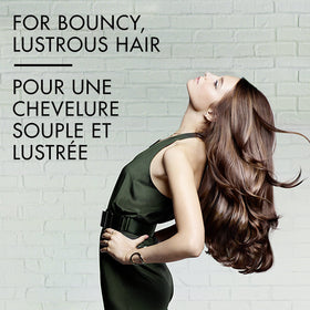 Nexxus conditioner dispensed on hand ready to apply offering easy spreadability