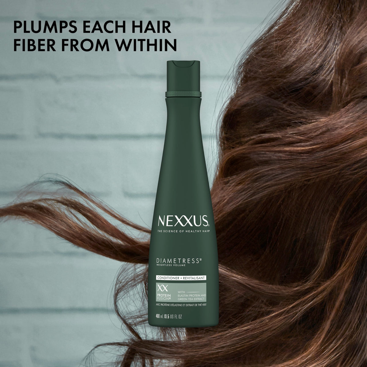 Nexxus bottle held next to hand illustrating the 13.5 oz size for value