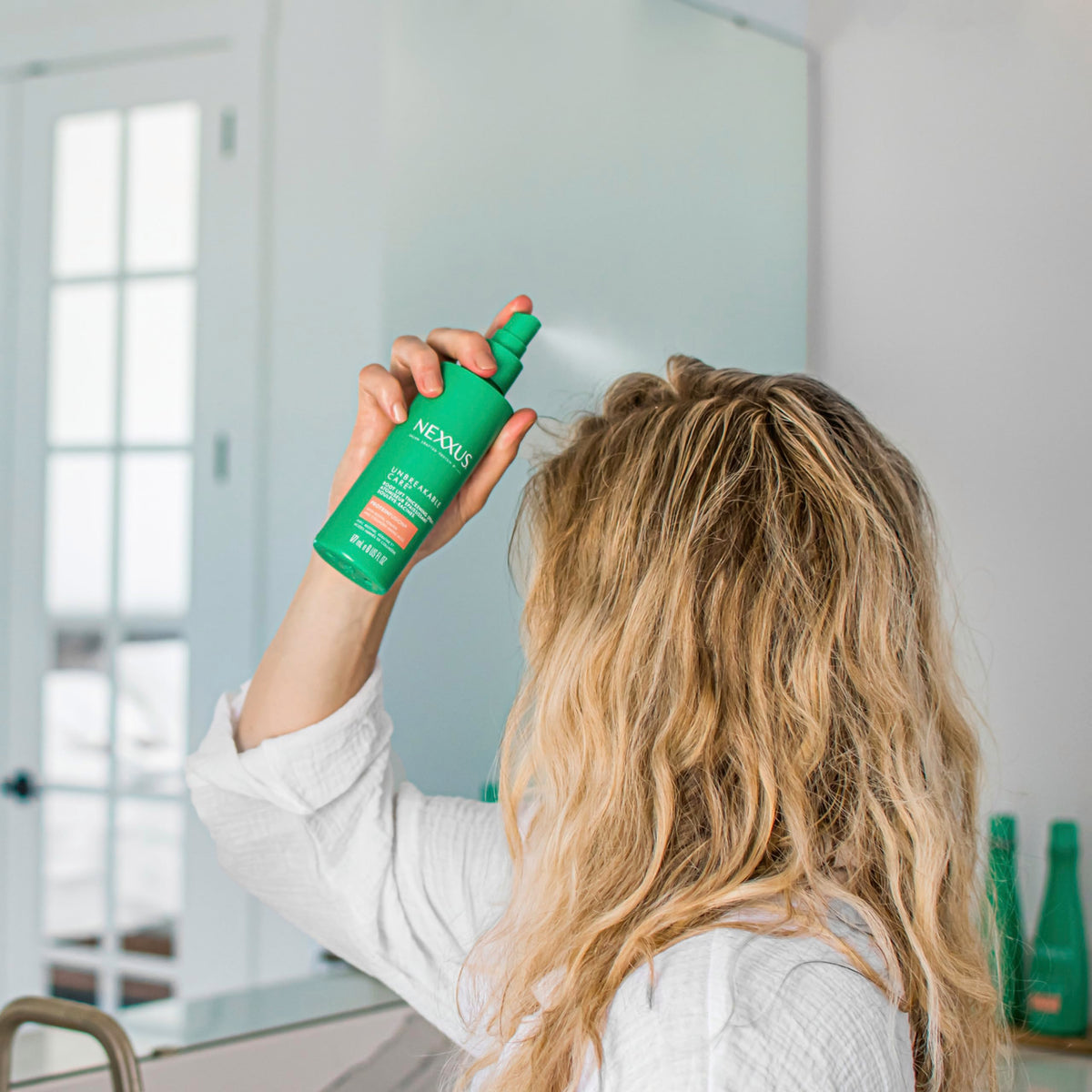 Nexxus lifestyle model with voluminous hair showing confidence benefit