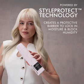 Nexxus bottle held in hand to show scale and portability for everyday use