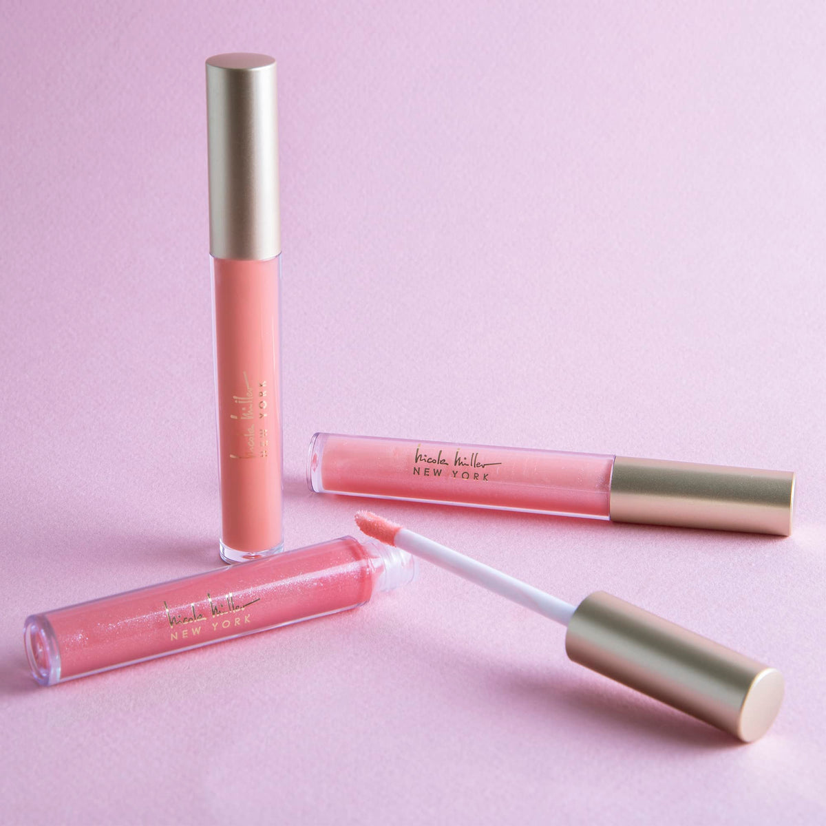 Nicole Miller New York open tube close-up highlighting applicator and glossy texture for smooth finish