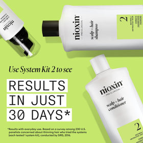 NIOXIN bottle held in hand to show 16.9 fl oz scale benefit