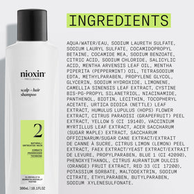 Nioxin bottle styled on bathroom shelf in lifestyle setting for daily care