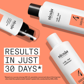 Nioxin System 4 leave-in applicator on scalp to boost volume