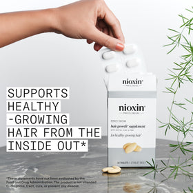NIOXIN tablet held in hand demonstrating easy daily use