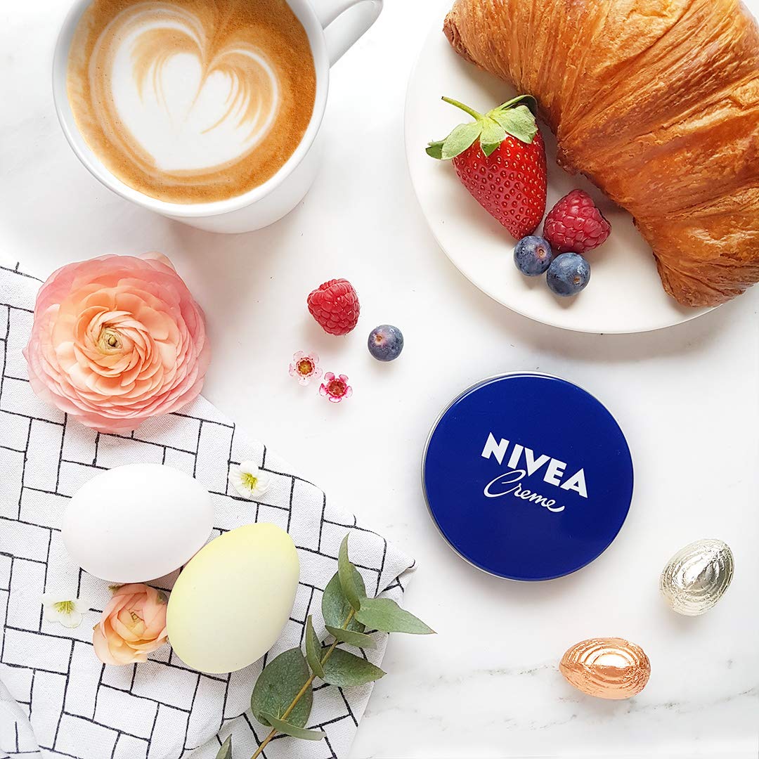 NIVEA creme beside bedside lamp illustrating overnight intensive skin care