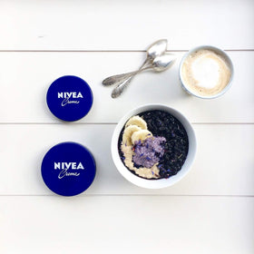 NIVEA creme next to a phone for size comparison and portability benefit