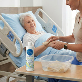 Caregiver using No-Rinse CleanLife on patient with quick clean result