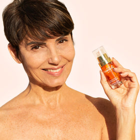 Noche Y Dia bottle on bathroom vanity illustrating daily skincare use