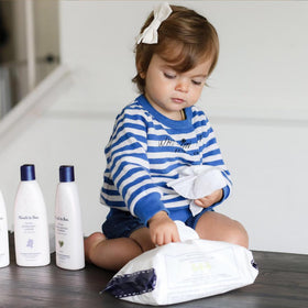 Noodle & Boo wipes on towel during baby bath, convenient gentle care