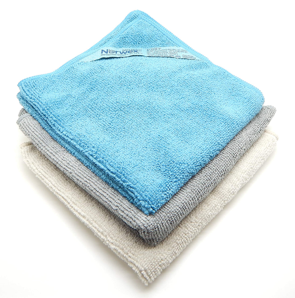 Norwex body pack coastal front view showing three colored cloths and compact packaging for convenience