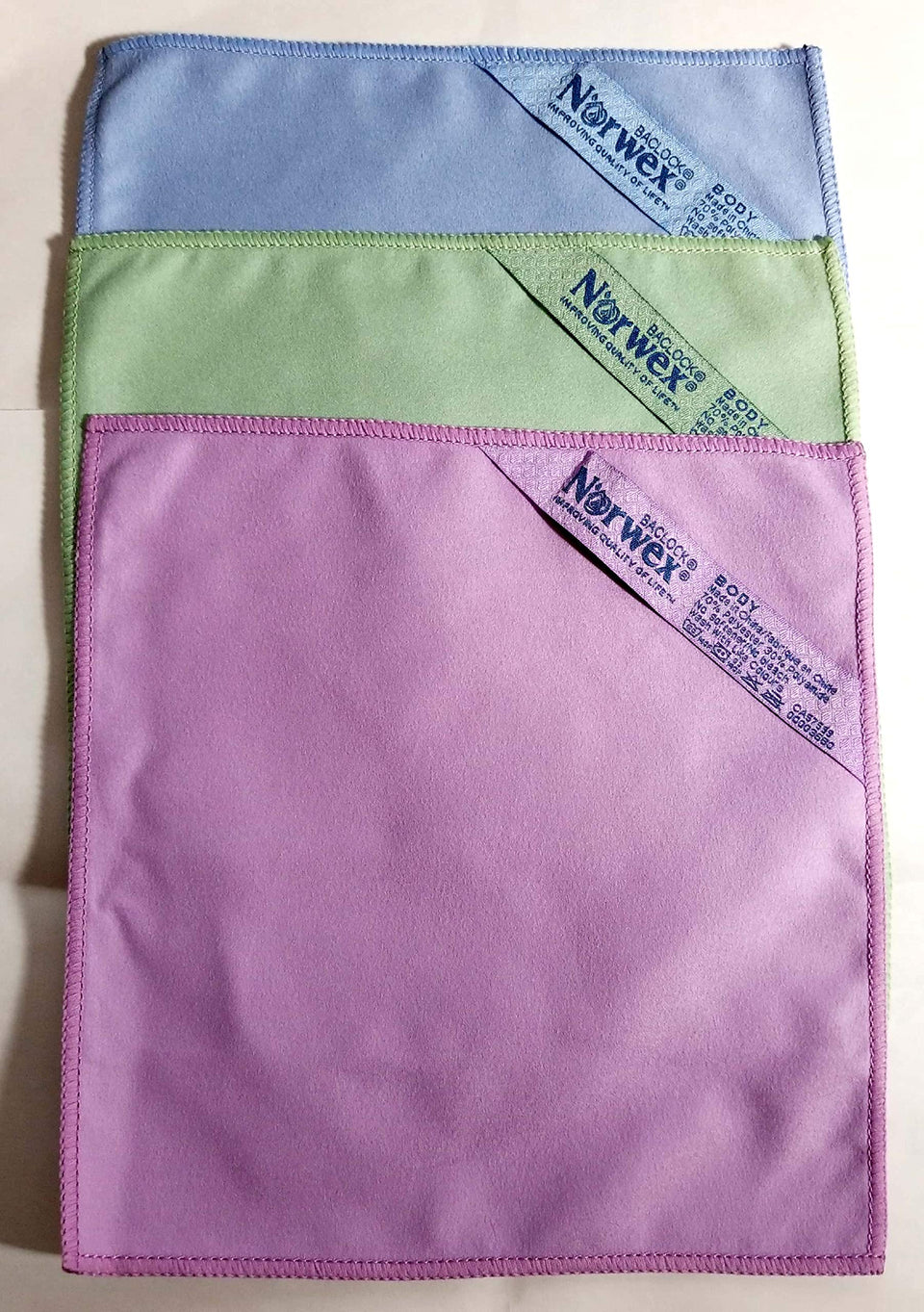 Norwex suede face cloth set front view showing three colors and gentle texture benefit