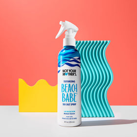 Not Your Mother's bottle held in hand to show 8 fl oz scale and travel-friendly size