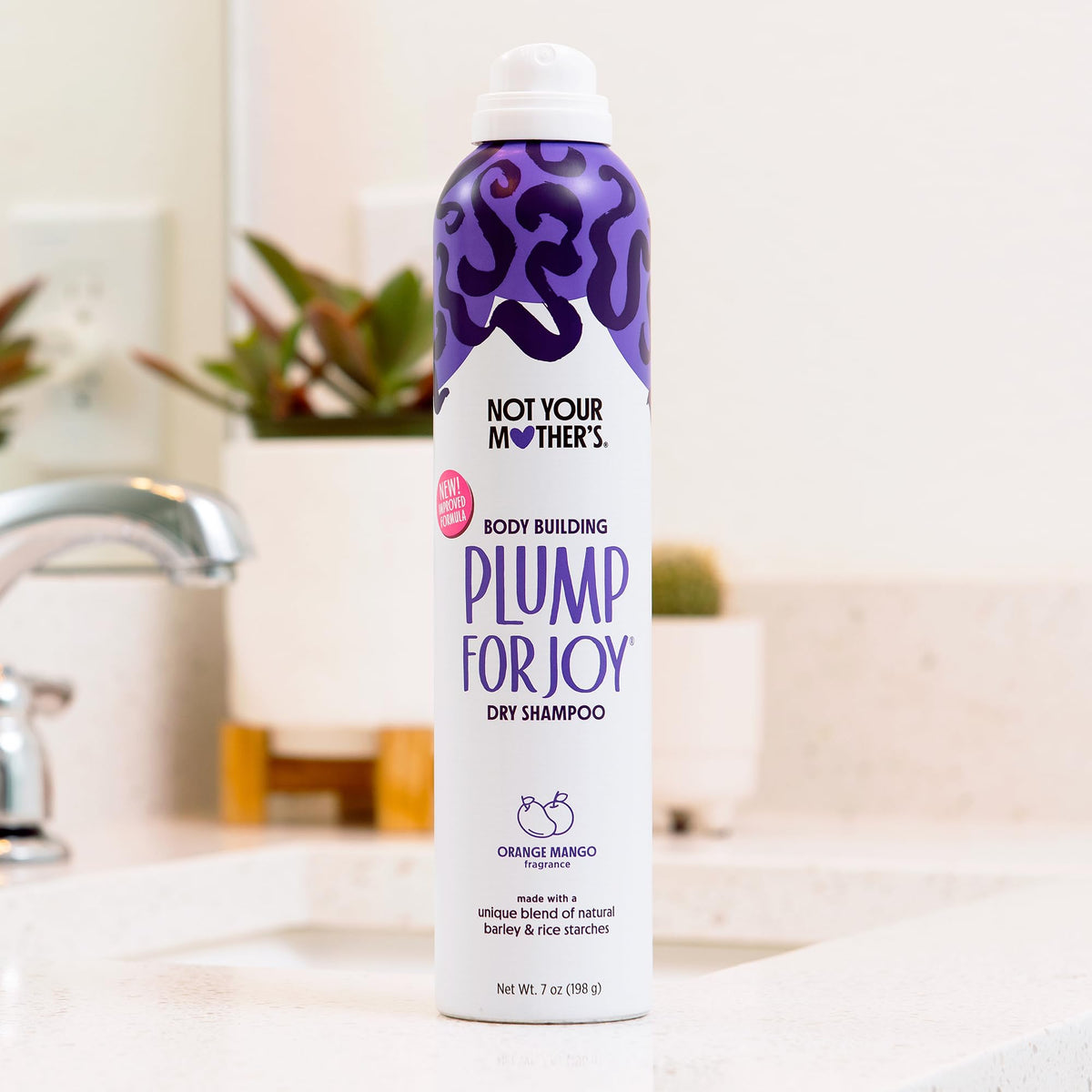 Not Your Mother's with orange and mango fruits highlighting bright, fresh fragrance