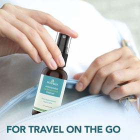 NOVEHA bottle in hand for scale showing 1 oz travel-friendly convenience benefit