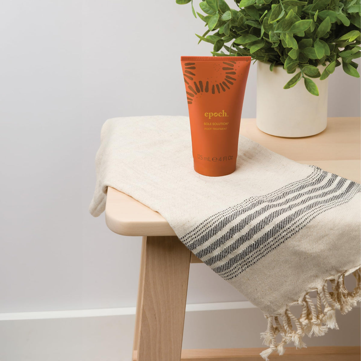 Nu Skin cream on nightstand with socks, suggests overnight treatment and enhanced results benefit