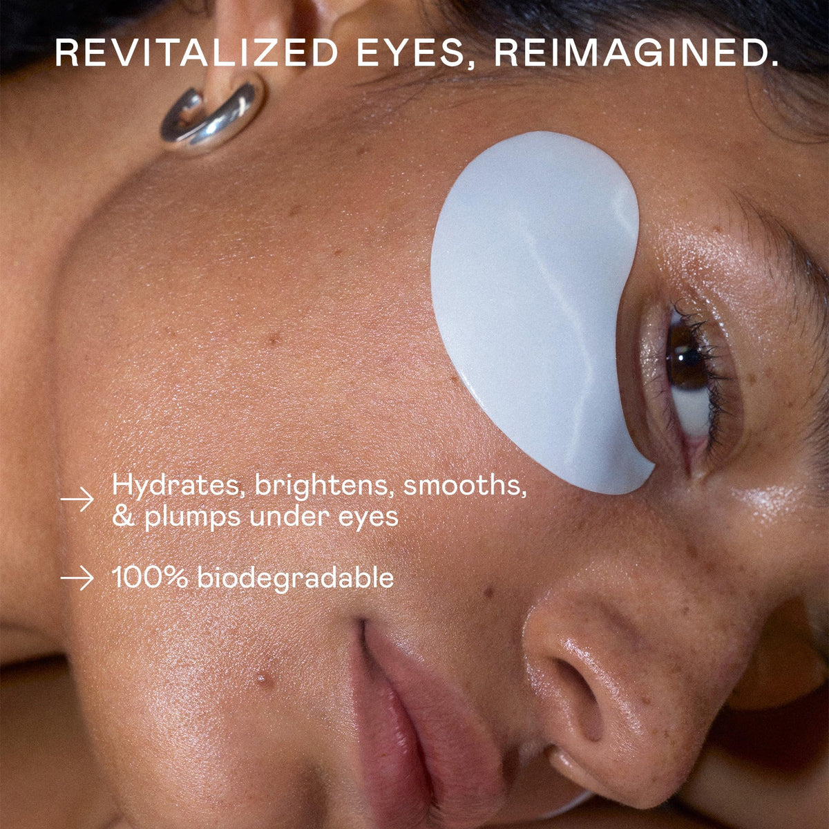 NUFACE close-up of a single hydrogel under-eye patch on fingertip, highlighting cushiony cooling texture