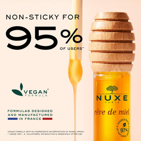 NUXE lip oil held in hand showing size and travel-friendly convenience benefit