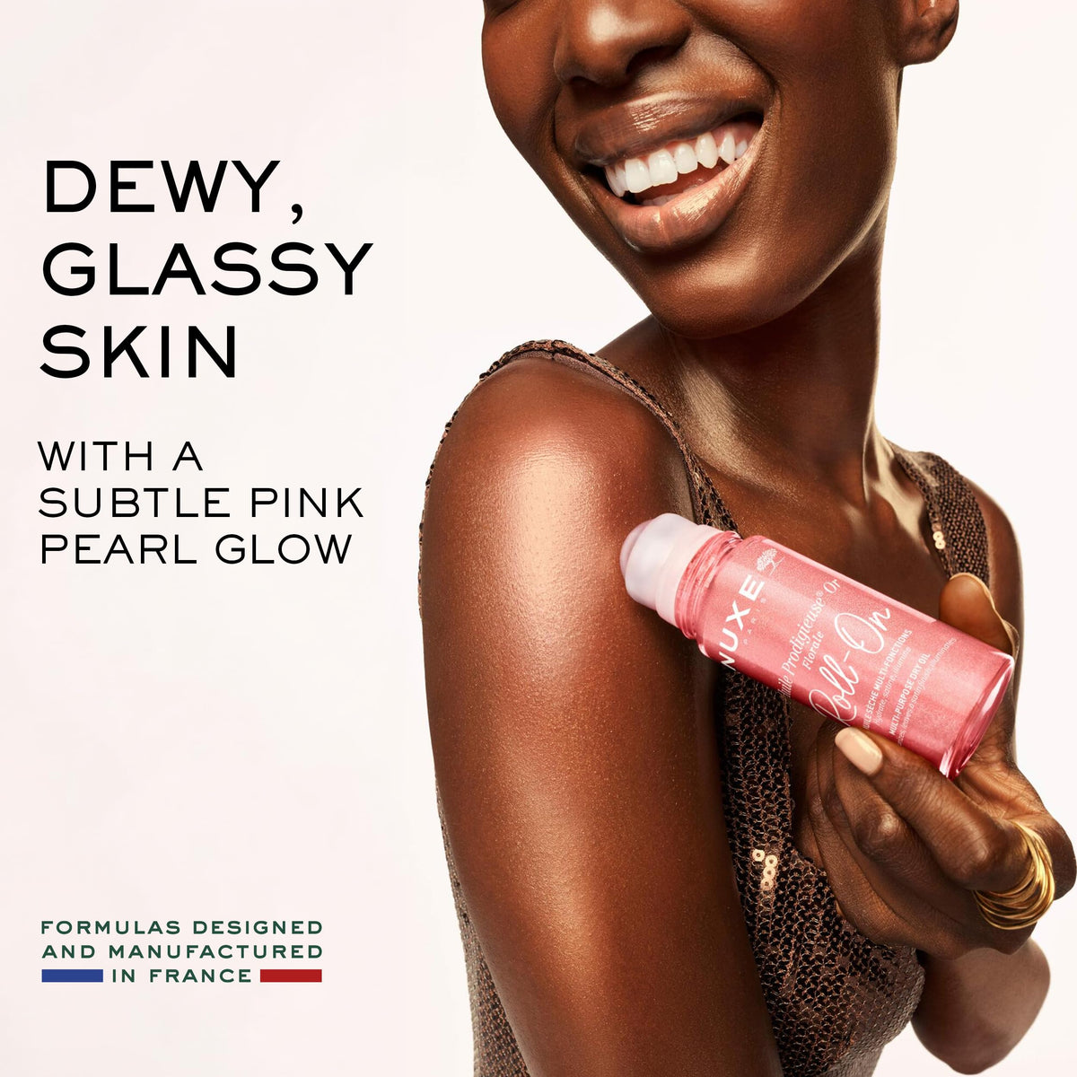 NUXE oil texture on skin with pink-gold shimmer delivering luminous finish