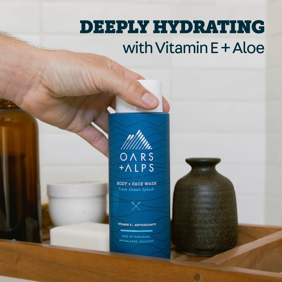 Oars + Alps bottle held to show size and convenient everyday use