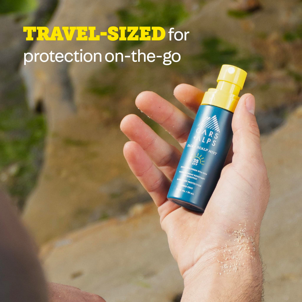 Oars + Alps sunscreen mist in beach setting protecting face and scalp