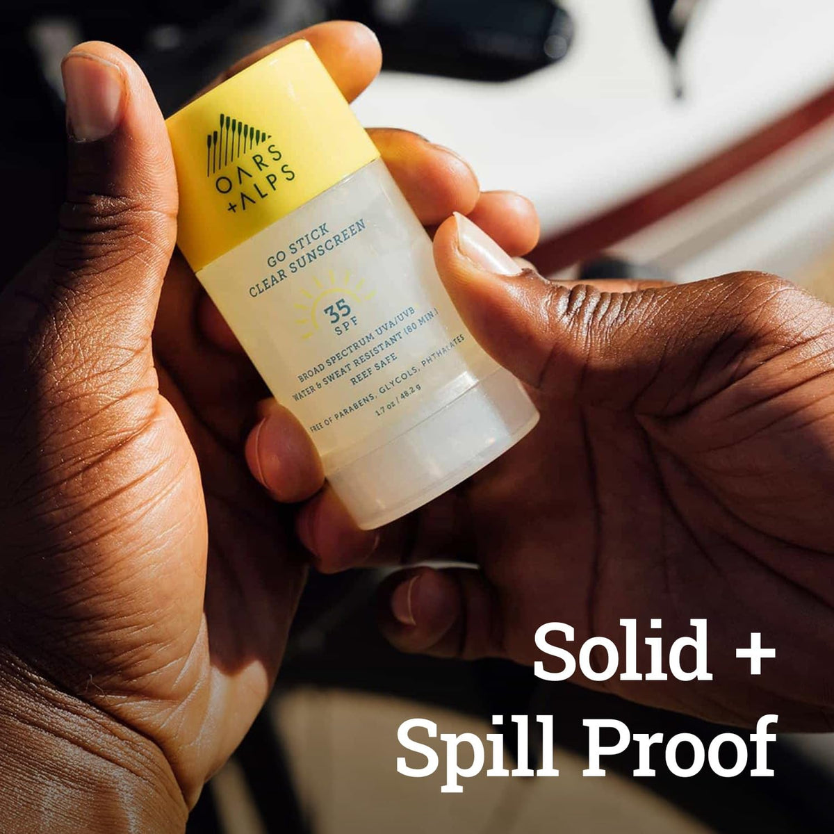 Oars + Alps sunscreen stick used at the beach showing water-resistant protection