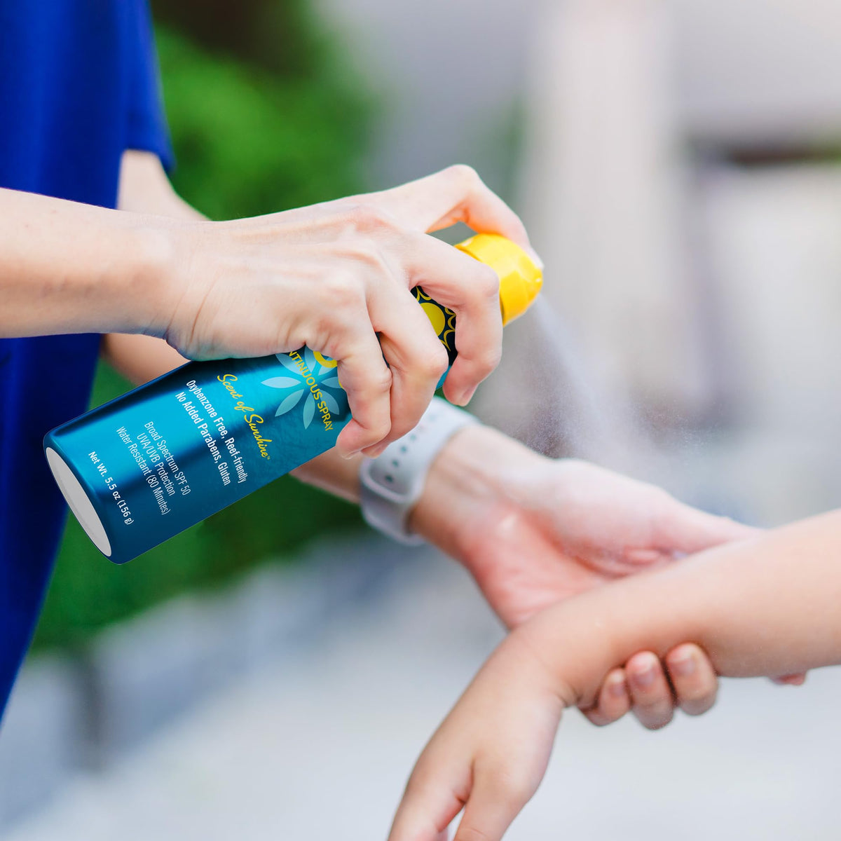Ocean Potion family applying spray outdoors for easy reapplication