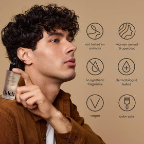 Odele bottle beside hairbrush lifestyle scene promoting everyday use