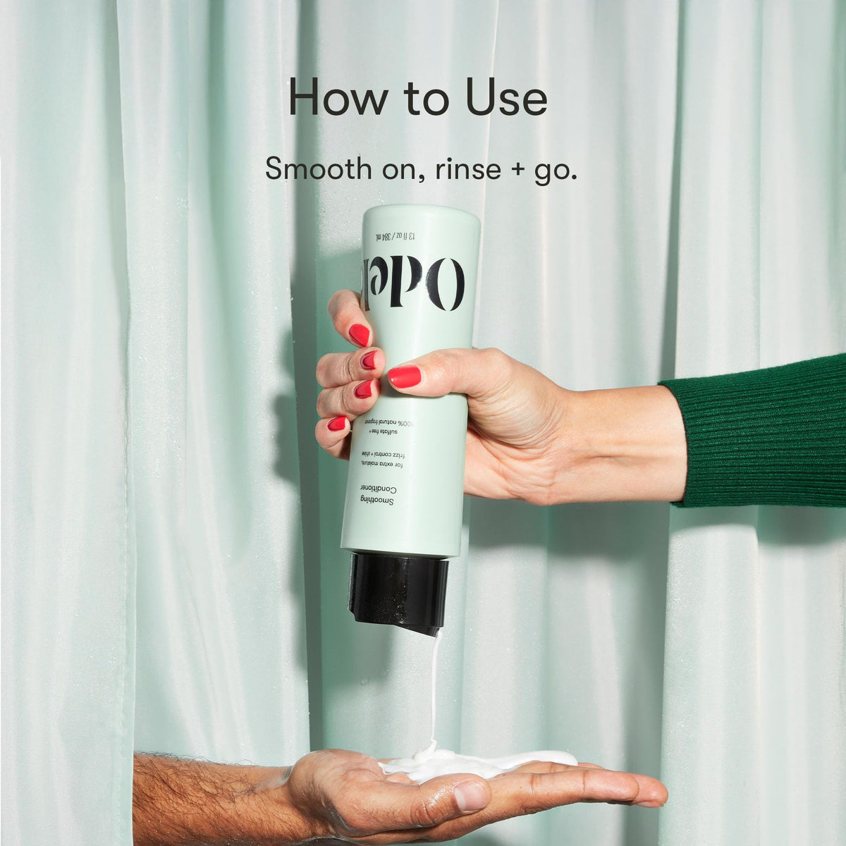 Odele conditioner held in hand to show 13 fl oz size and scale