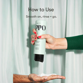 Odele conditioner held in hand to show 13 fl oz size and scale