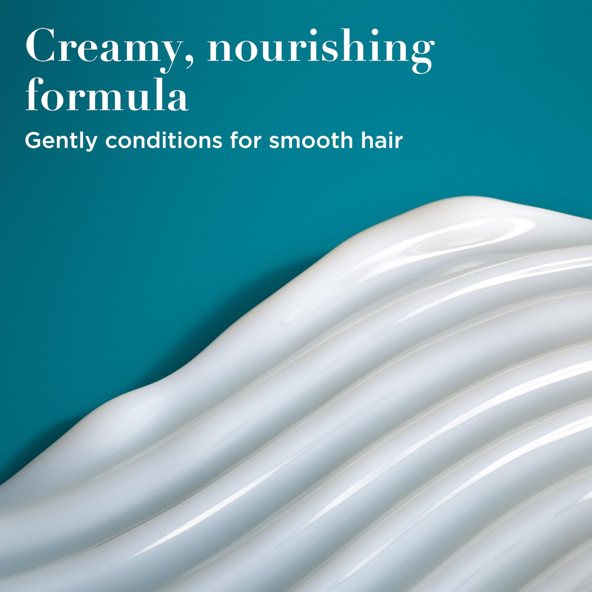 OGX creamy conditioner texture close-up demonstrating rich hydration benefit