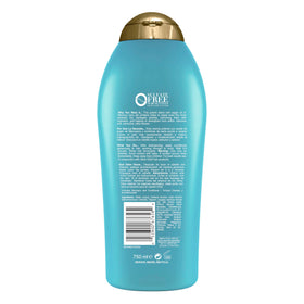 OGX 25.4 fl oz bottle next to common object to show scale