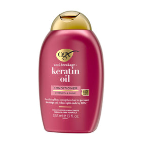 OGX 13 fl oz bottle in hand indicating true size and travel-friendly benefit