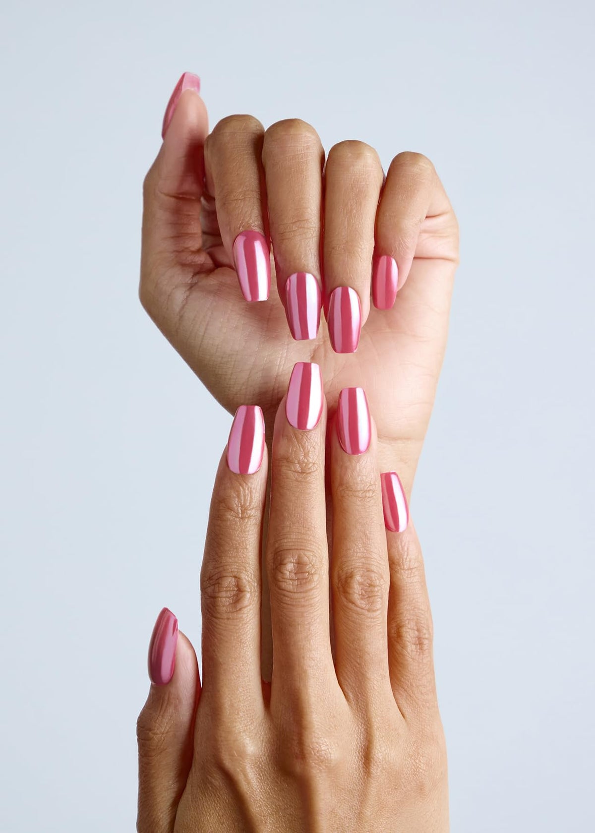 ohora on model hand lifestyle shot showing pink chrome nails and polished glossy benefit